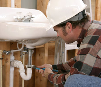 plumber fixing a water sink